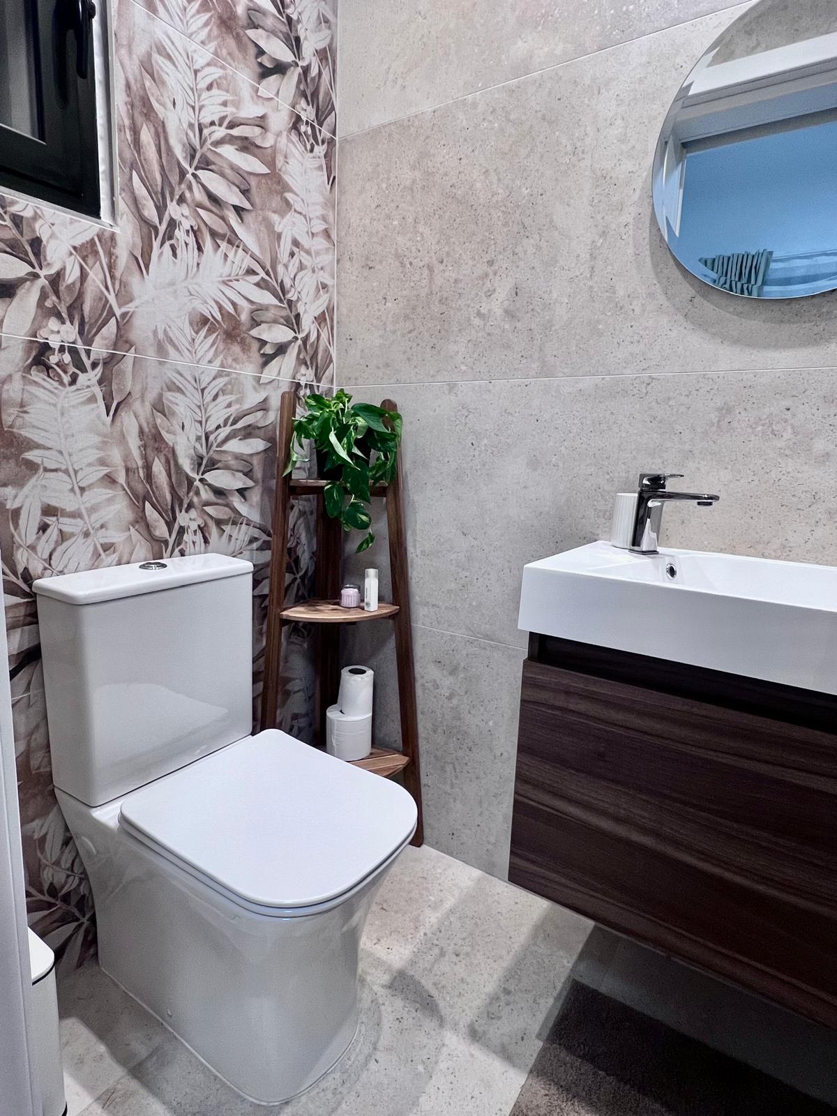Stylish bathroom with botanical feature wall